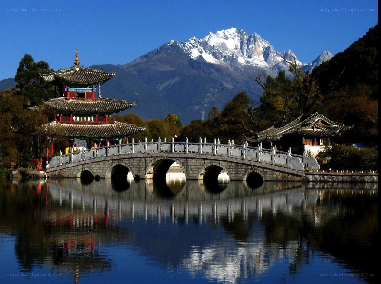 Pagoda by a lake with mountain