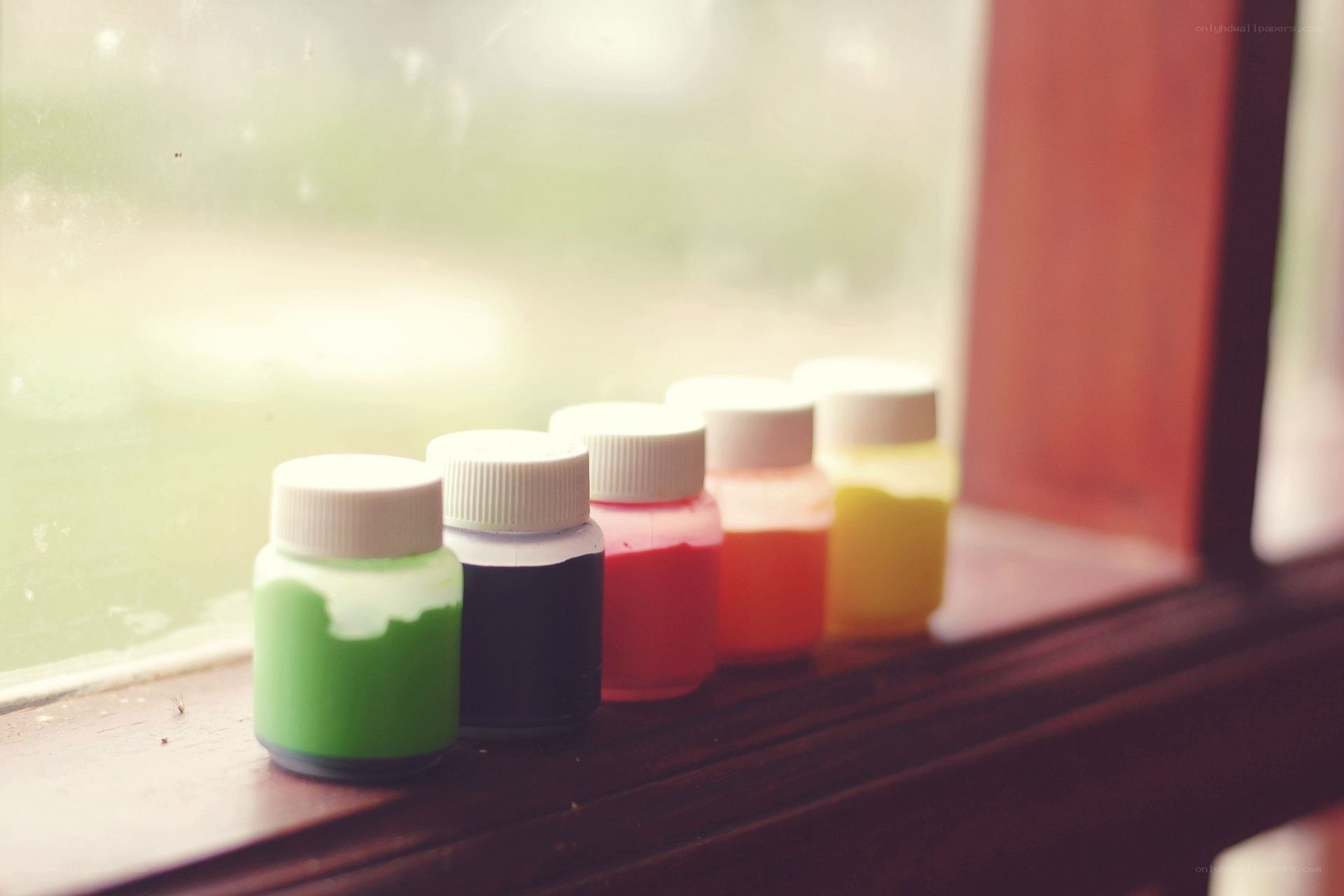 paint bottles on a windowsill