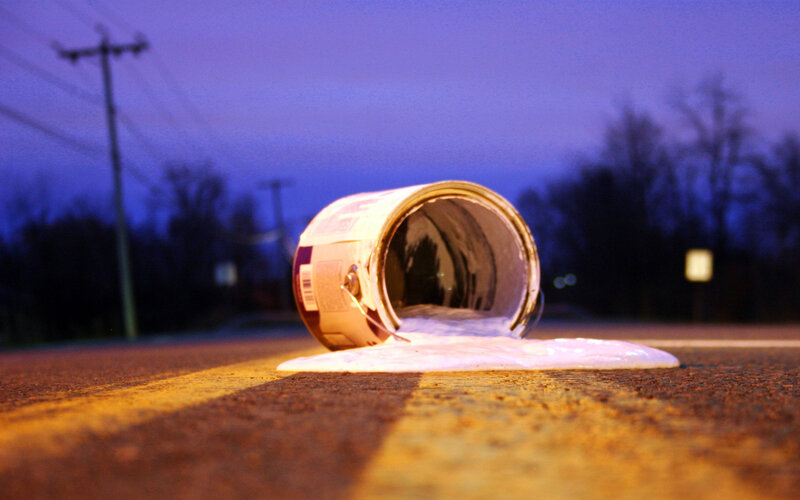 Paint spilled on road at dusk