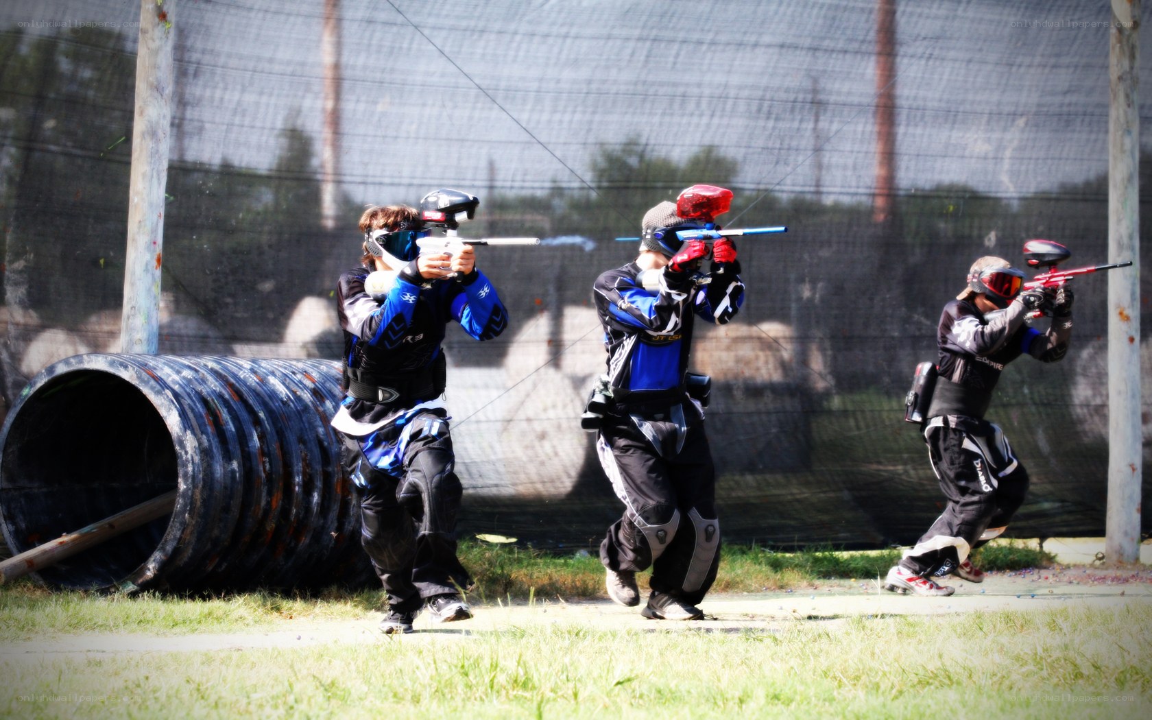 Paintball players in action