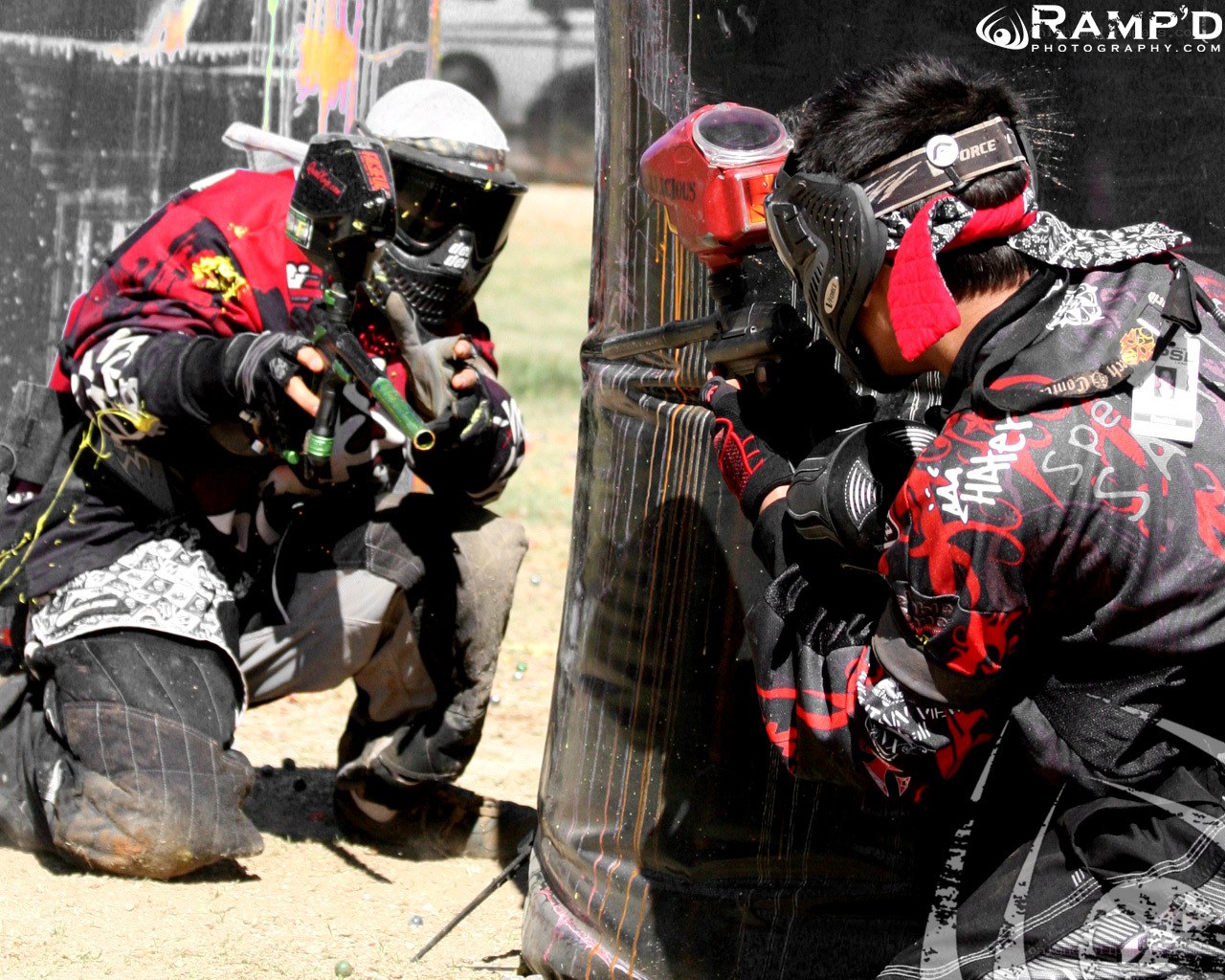 Paintball players in action