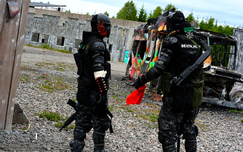 Paintball players in combat gear