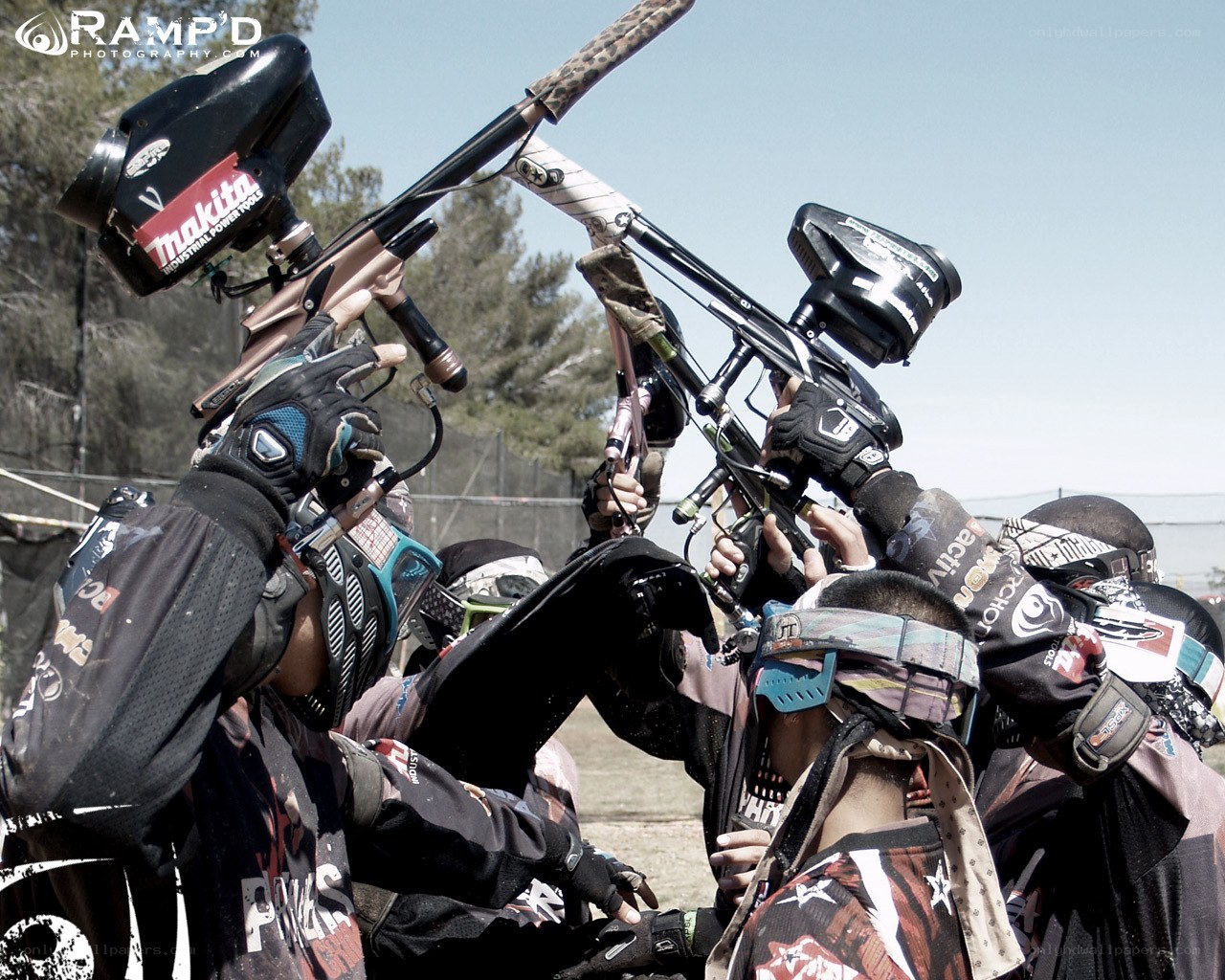 Paintball players in huddle