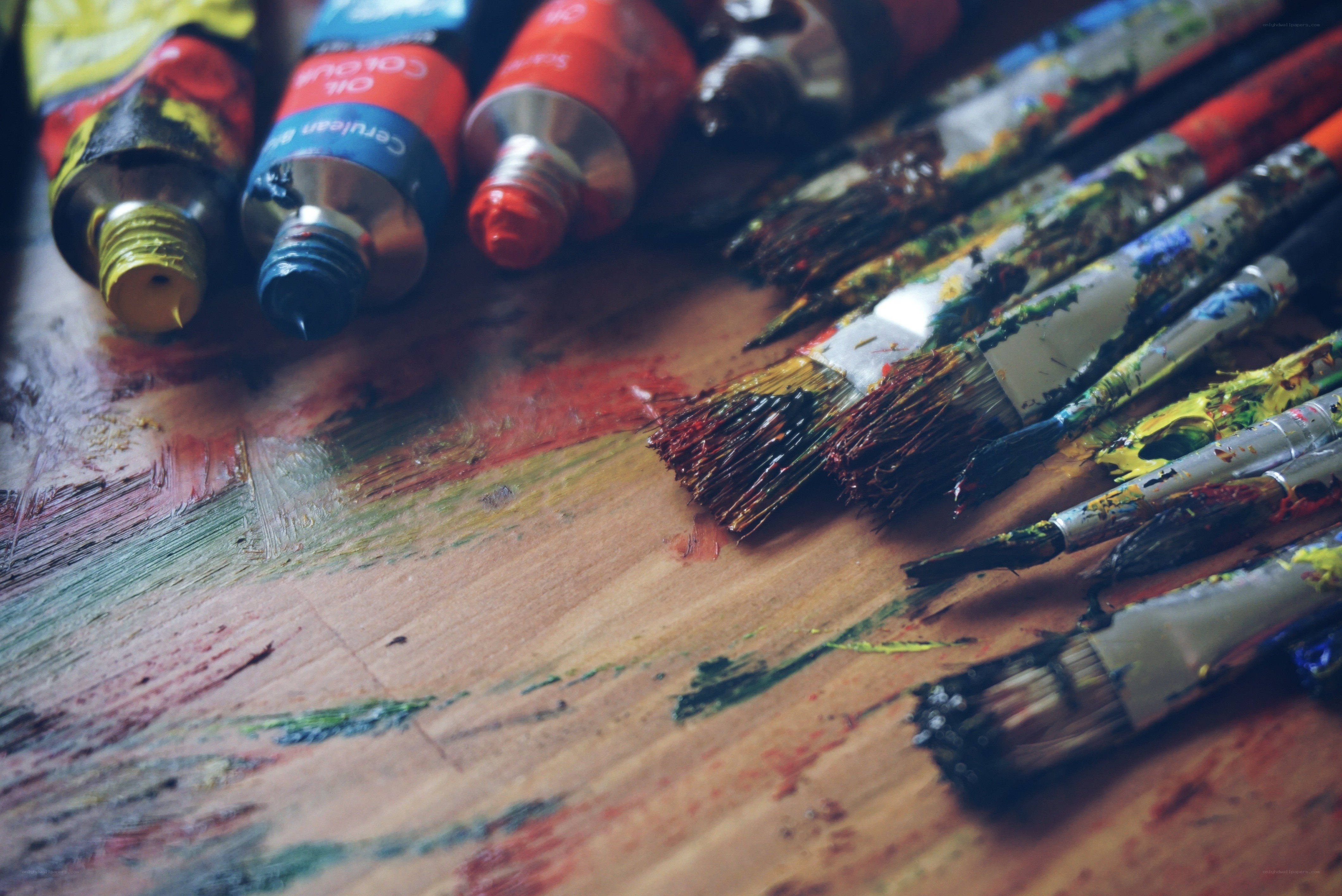Paintbrushes and paint tubes on a palette