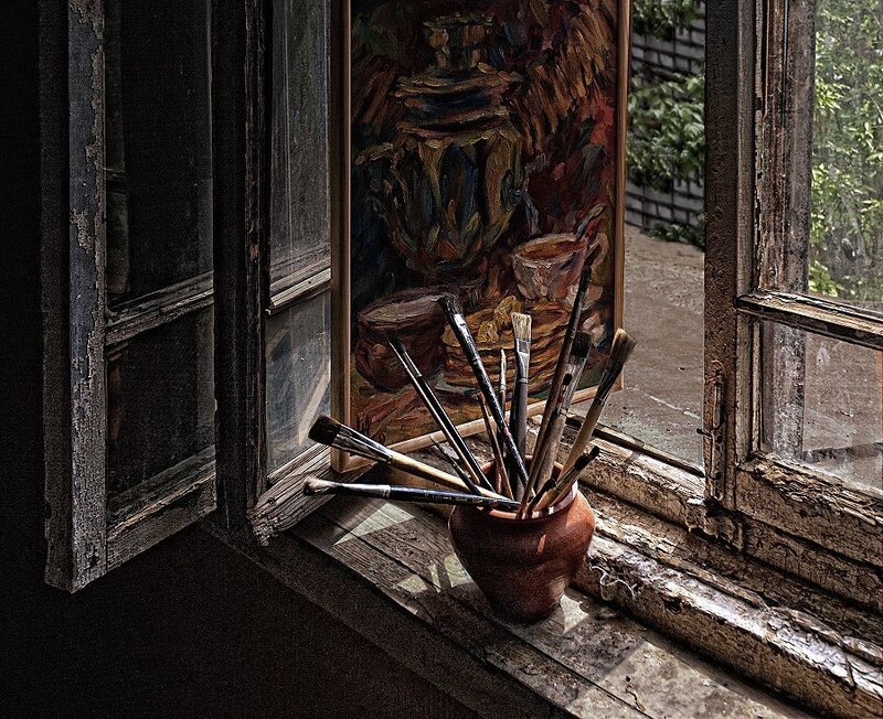 Paintbrushes in a window