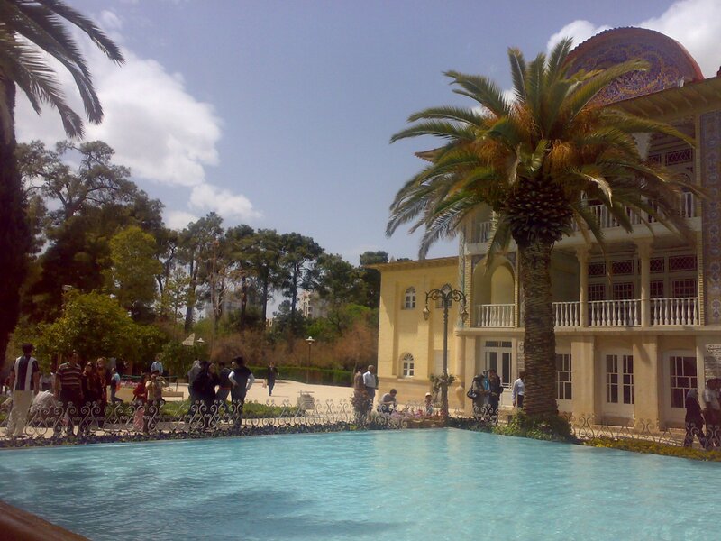 Palace with pool and palm trees