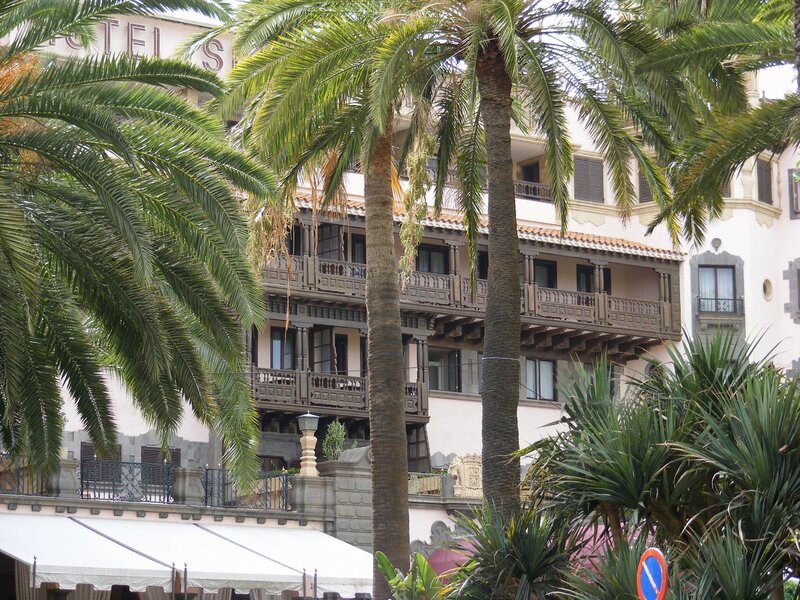 Palm trees in front of a hotel