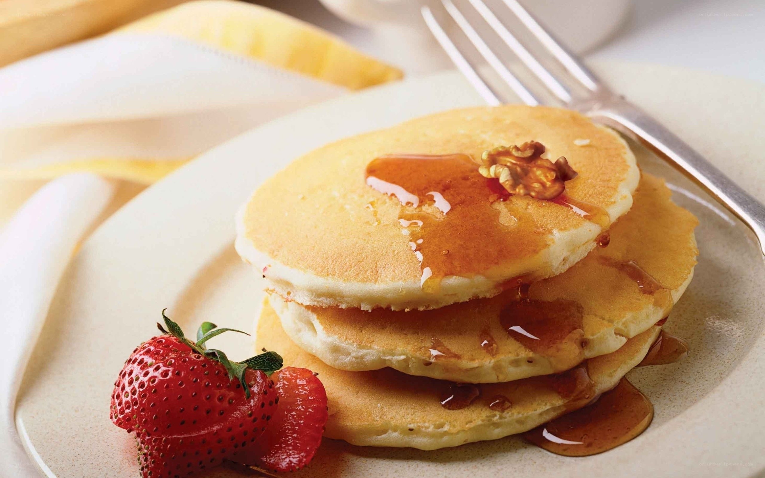 Pancakes with syrup and strawberry
