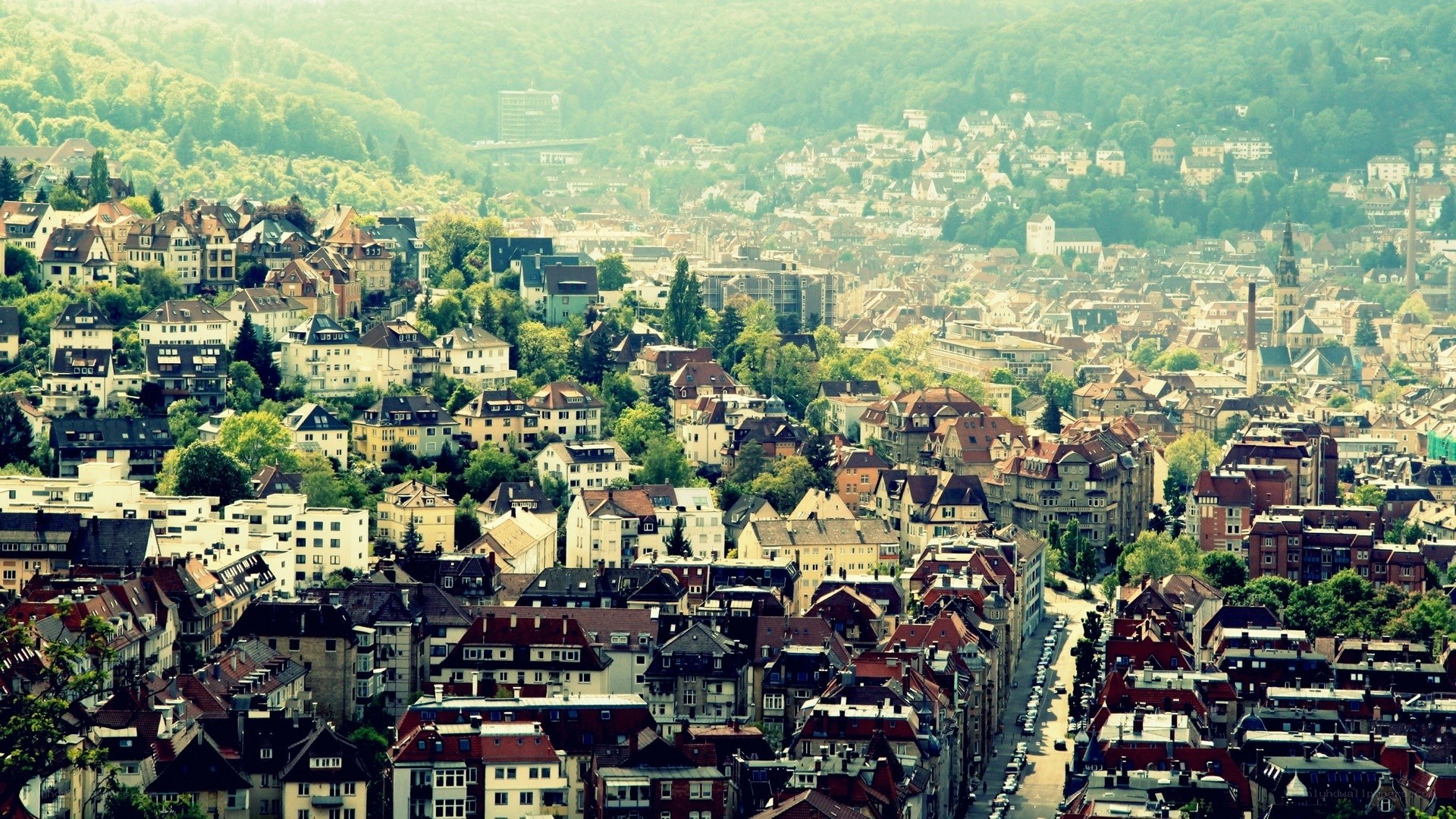 panoramic city view with green hills