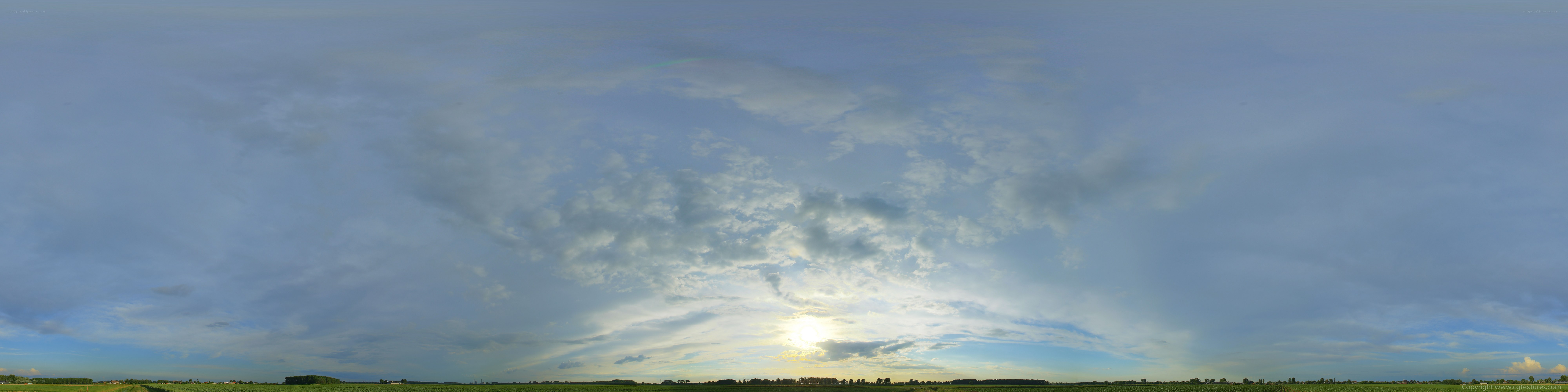 Panoramic sky over green fields