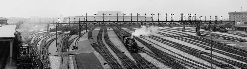 Panoramic view of a busy train station