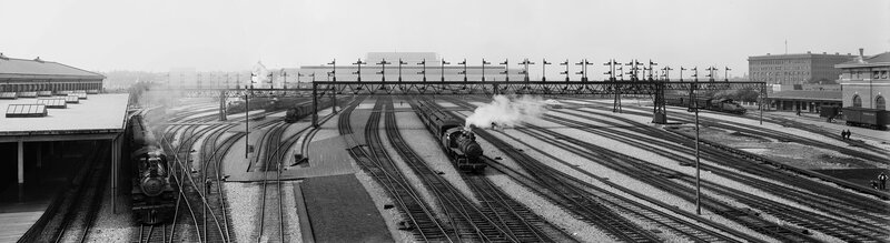 Panoramic view of a busy train station