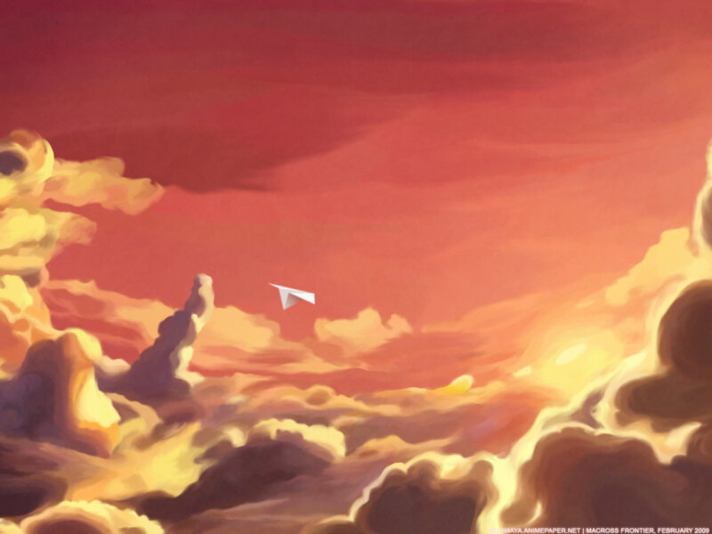 Paper airplane in sunset sky