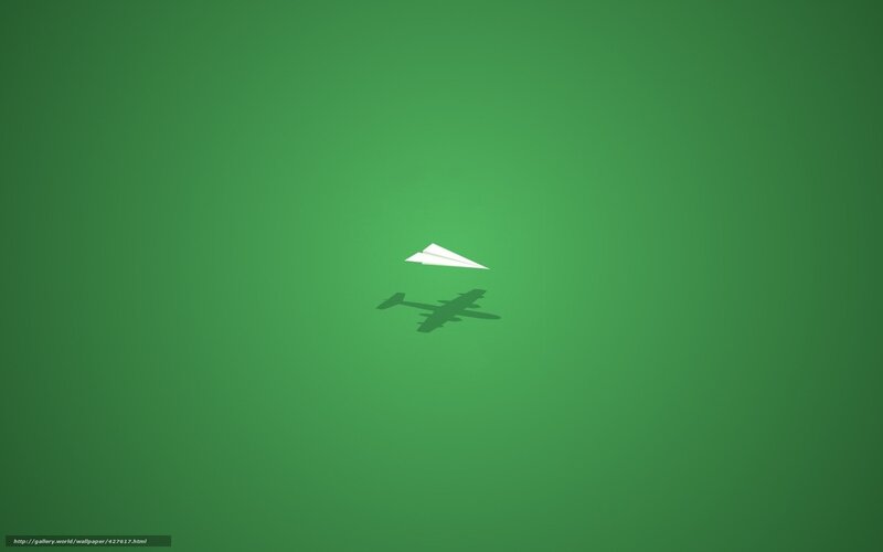 Paper airplane on green
