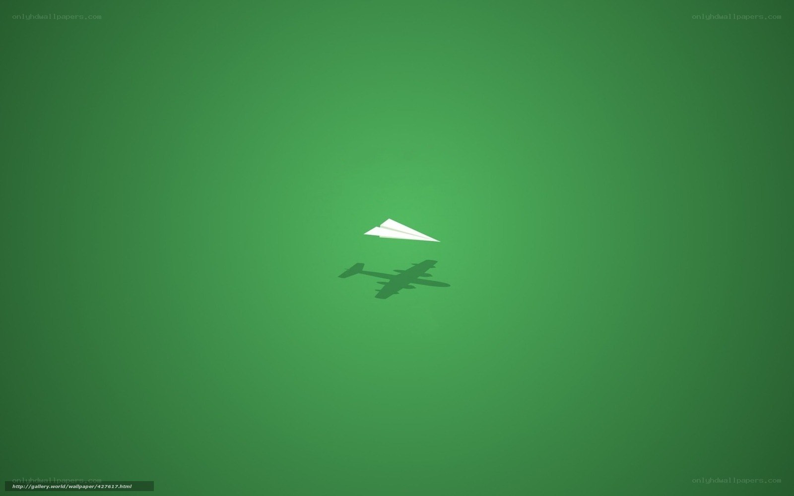 Paper airplane on green