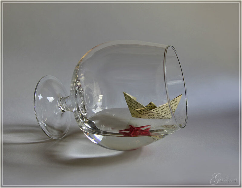 Paper boat in a glass