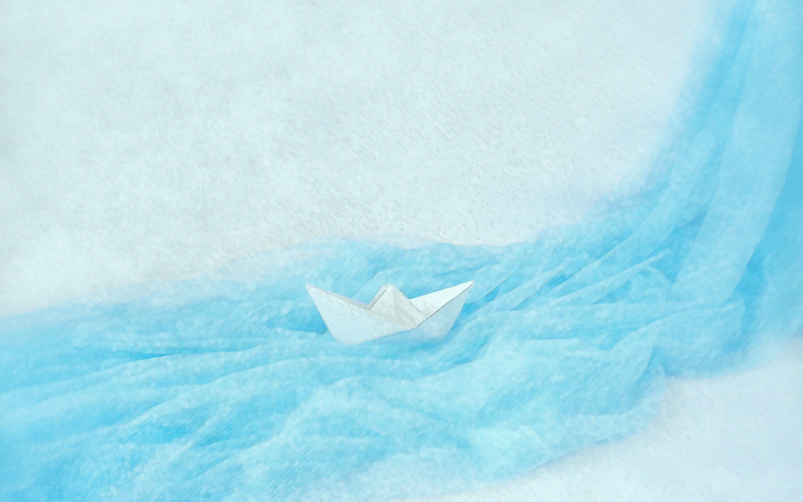 paper boat on blue fabric