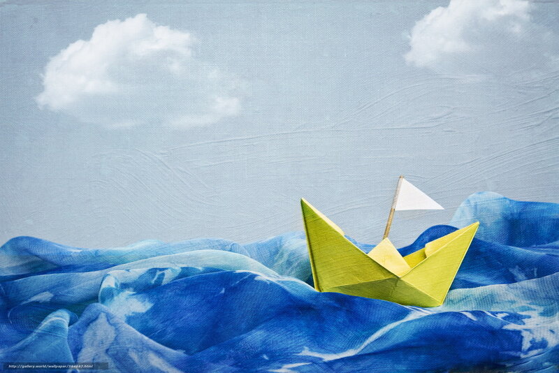 Paper boat on blue waves