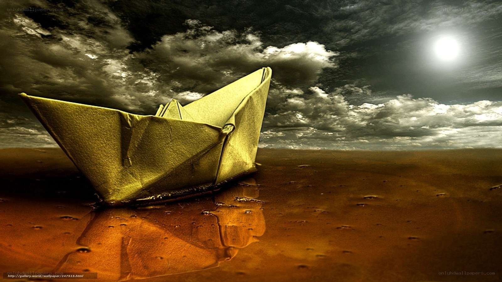 Paper boat on wet sand