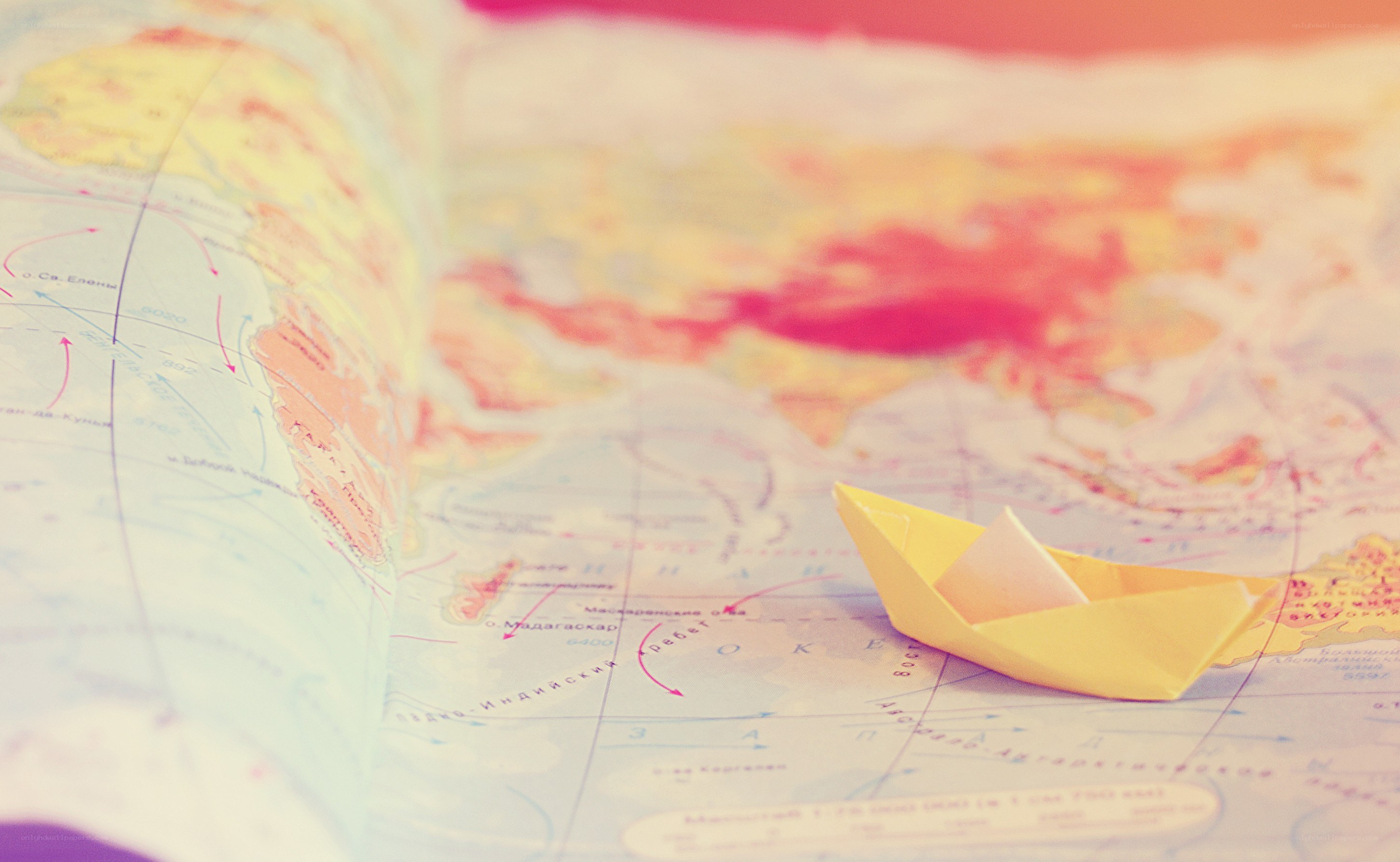 paper boat on world map