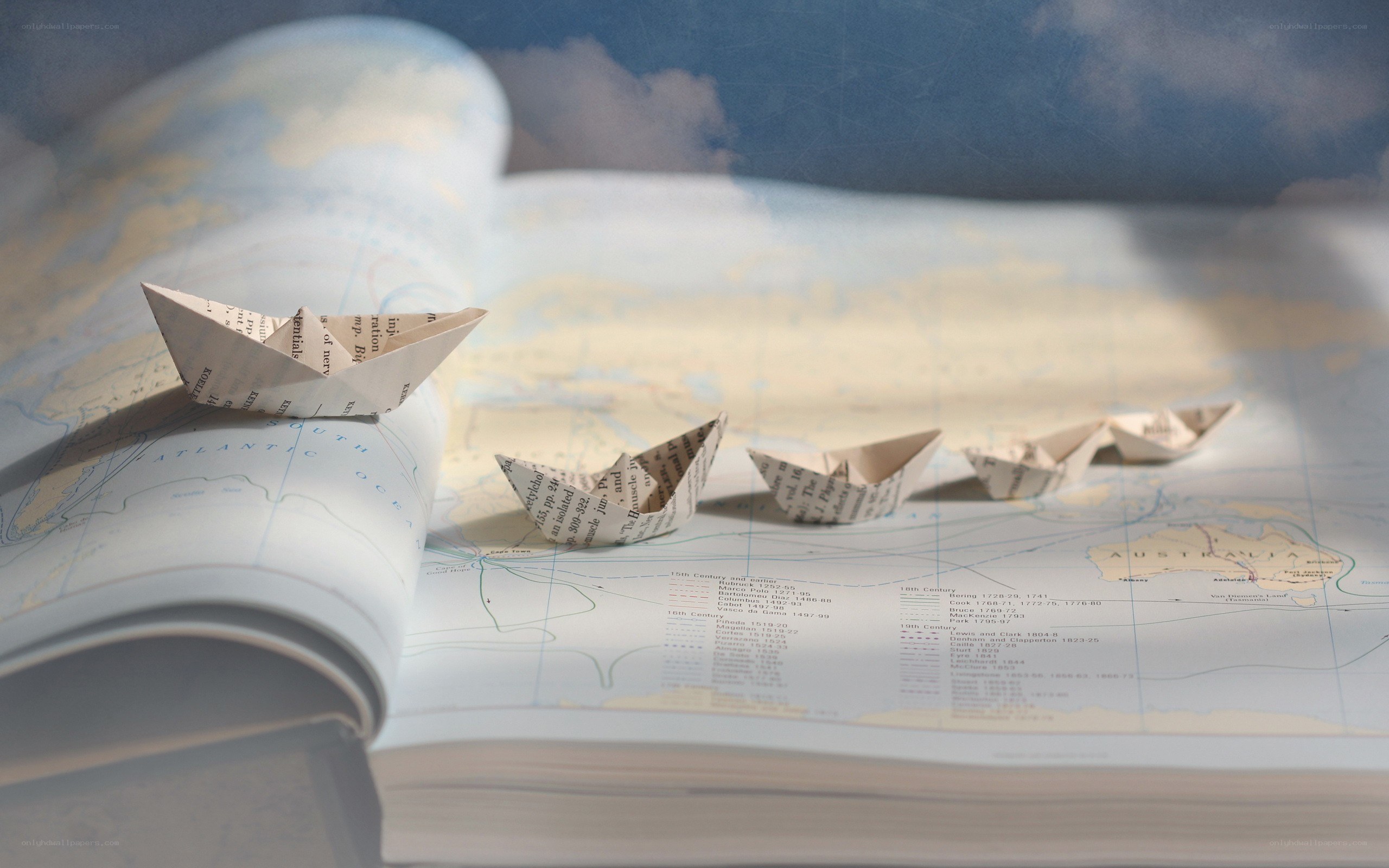 Paper boats on a world map
