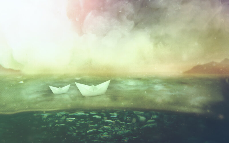 Paper boats on calm water