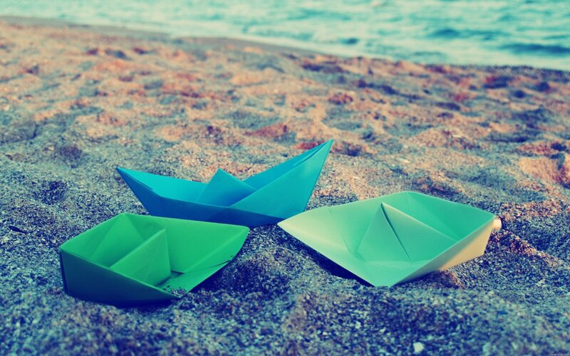 paper boats on the beach