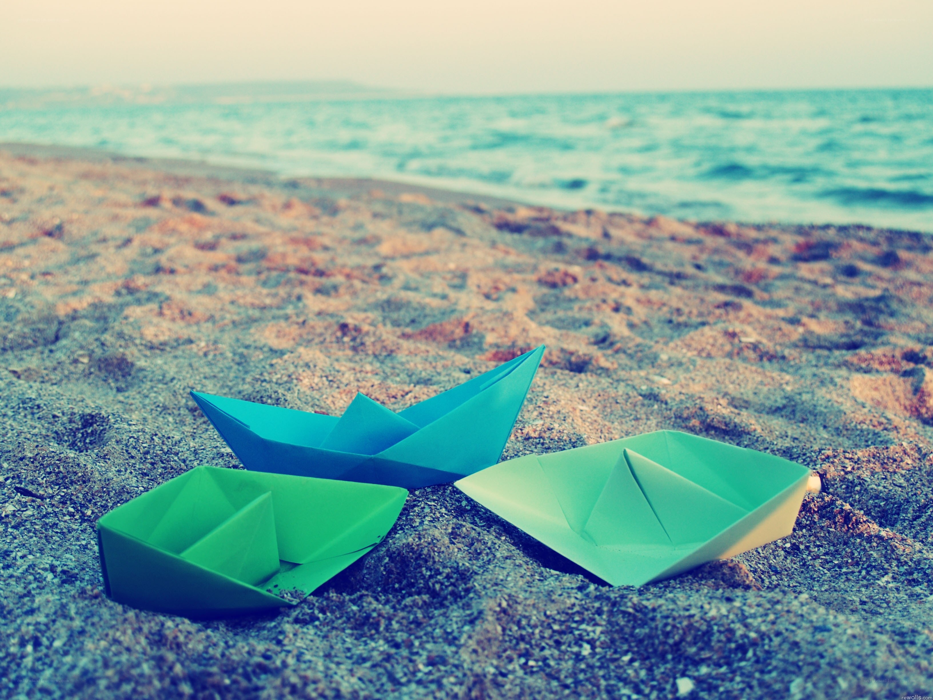 Paper boats on the beach