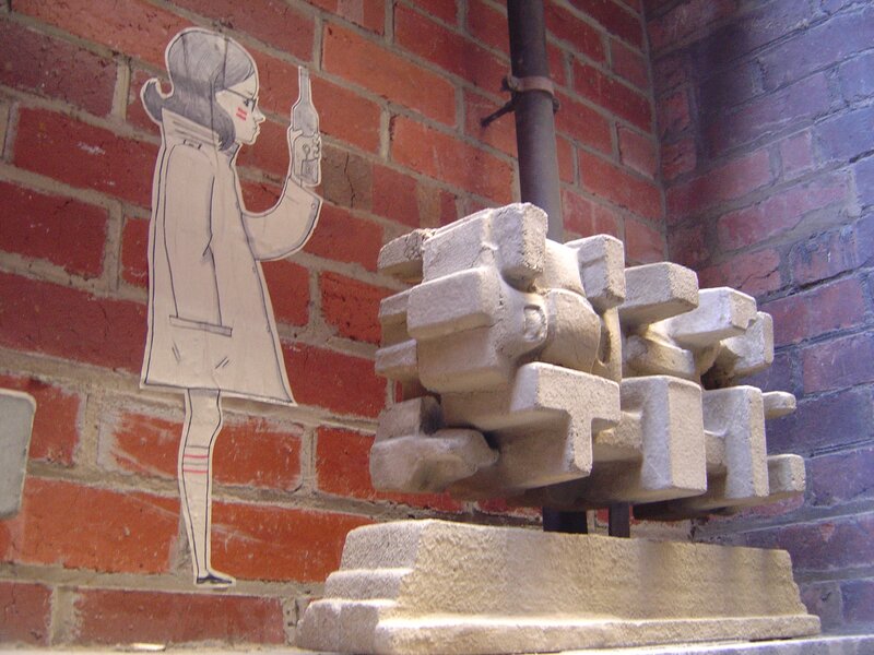 paper cutout girl on brick wall