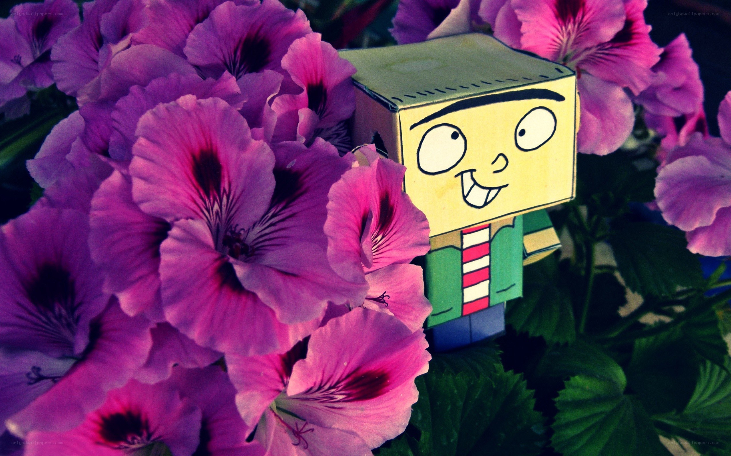 Paper figure among purple flowers
