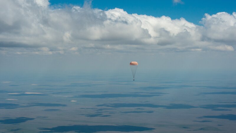 Parachute Descending over Ocean