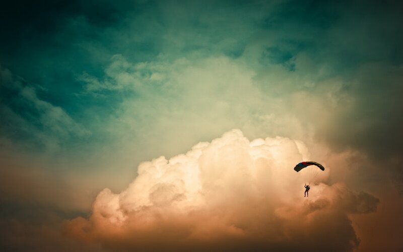 Parachutist above the clouds