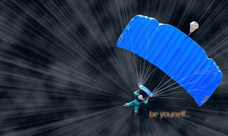 Parachutist in blue canopy