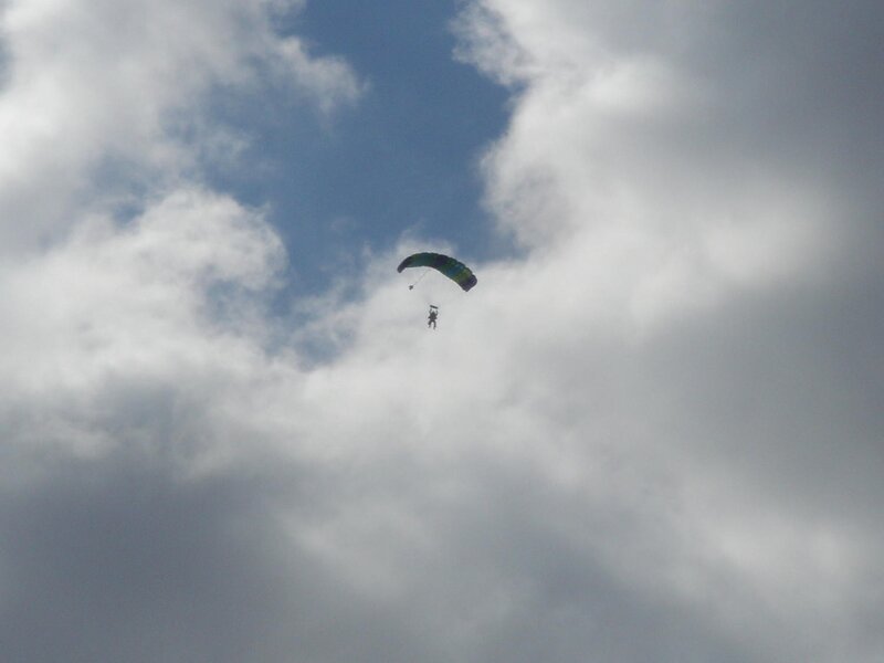 Parachutist in cloudy sky