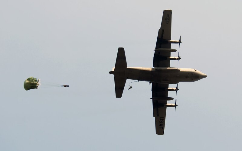 Parachutist Jumping from Plane — Gray