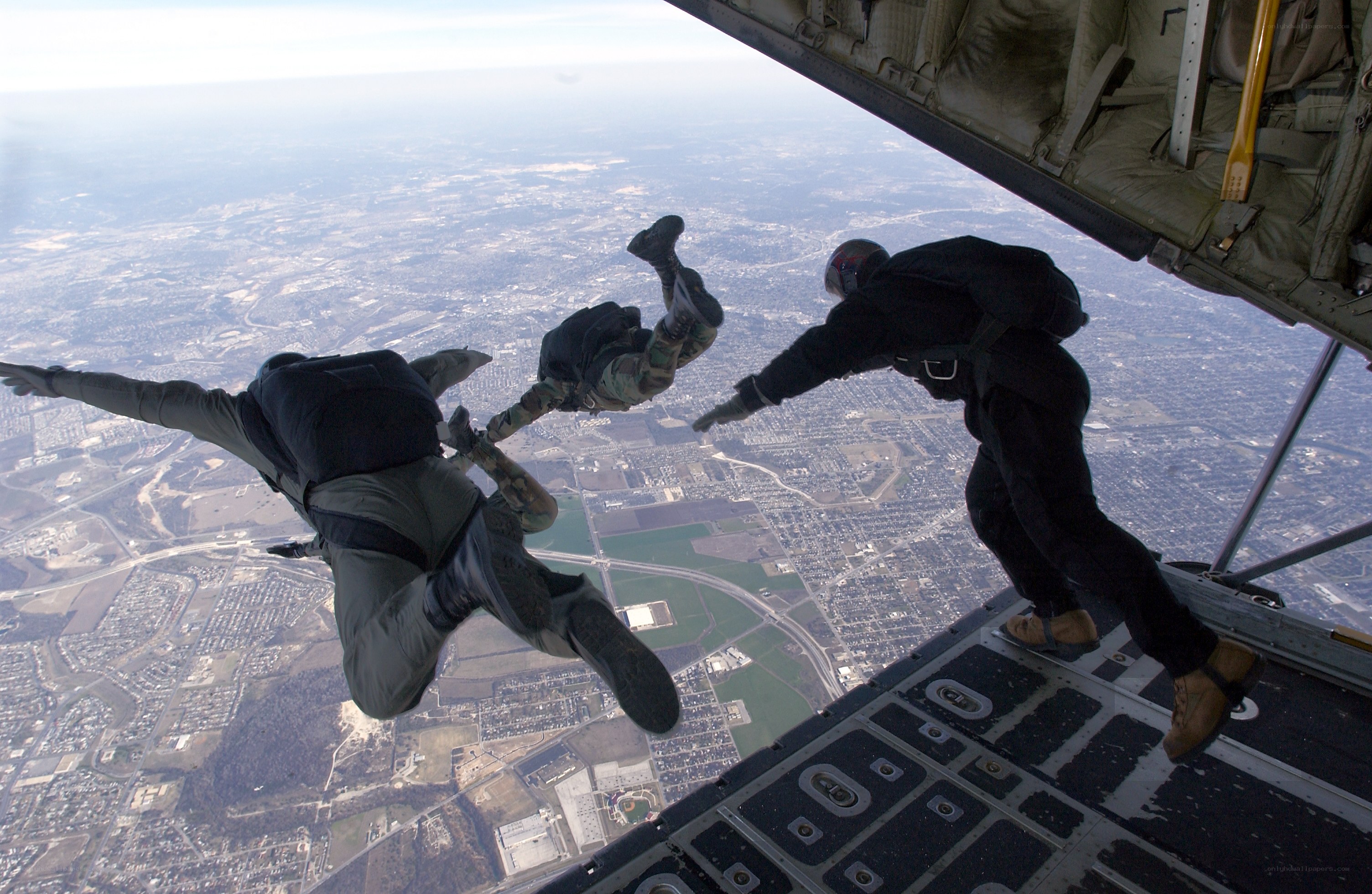 Parachutists jumping from aircraft