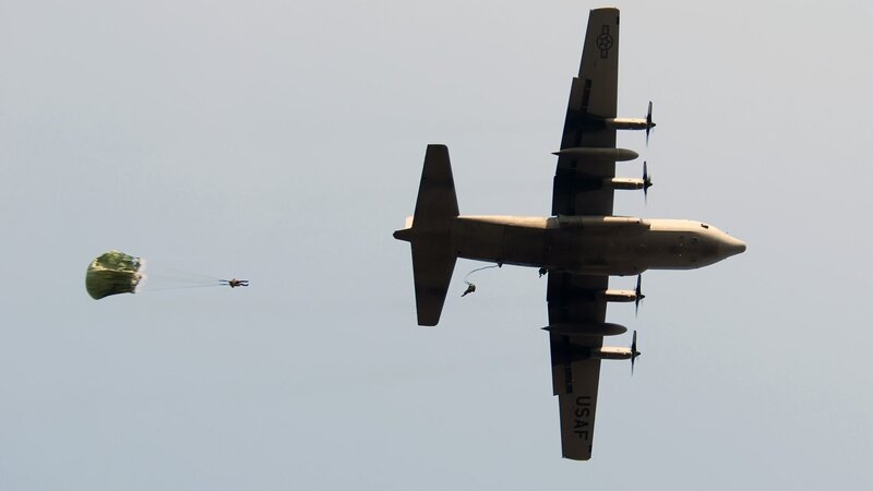 Parachutists Jumping from Plane — Gray