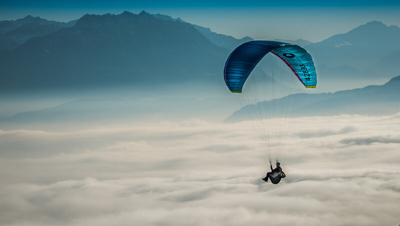 Paraglider Above Clouds — Blue, Serene