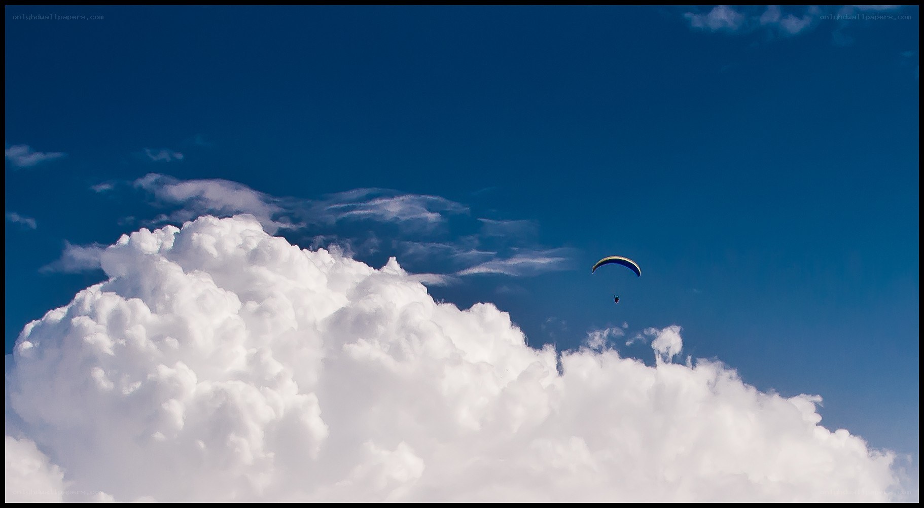 Paraglider above clouds