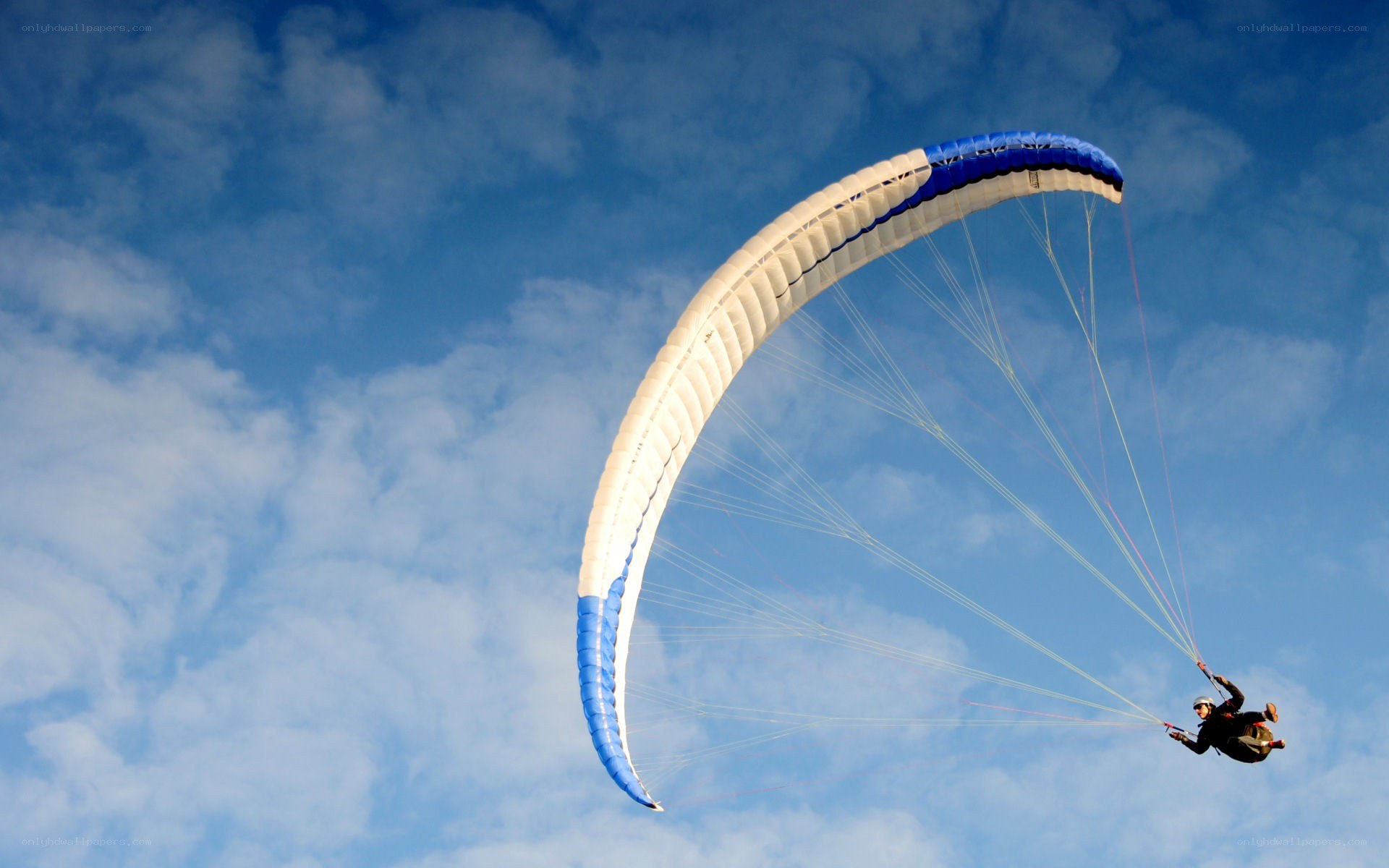 Paraglider in blue sky