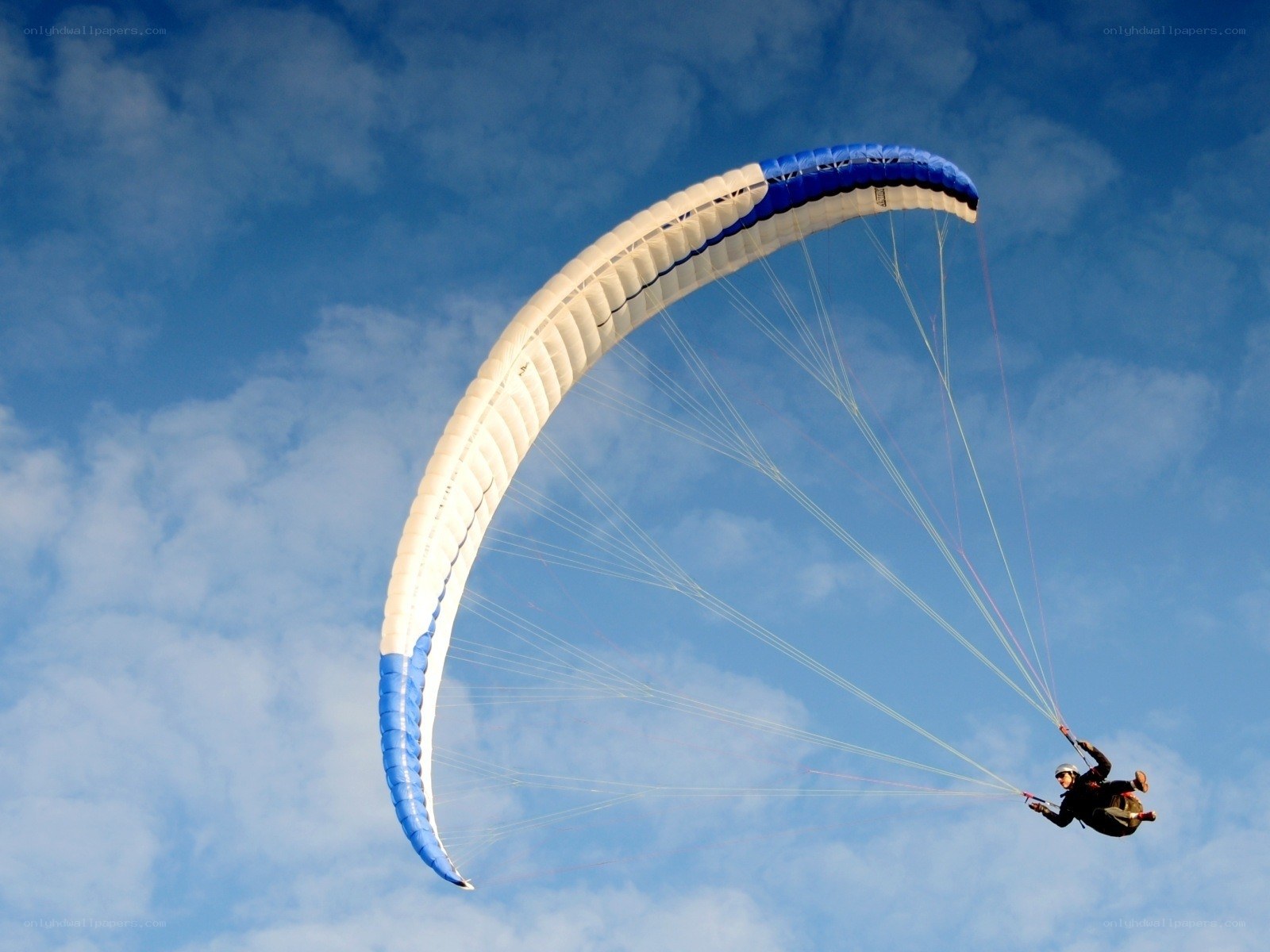 Paraglider in blue sky