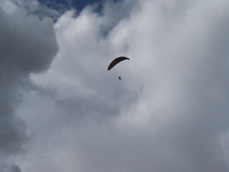 Paraglider in Cloudy Sky