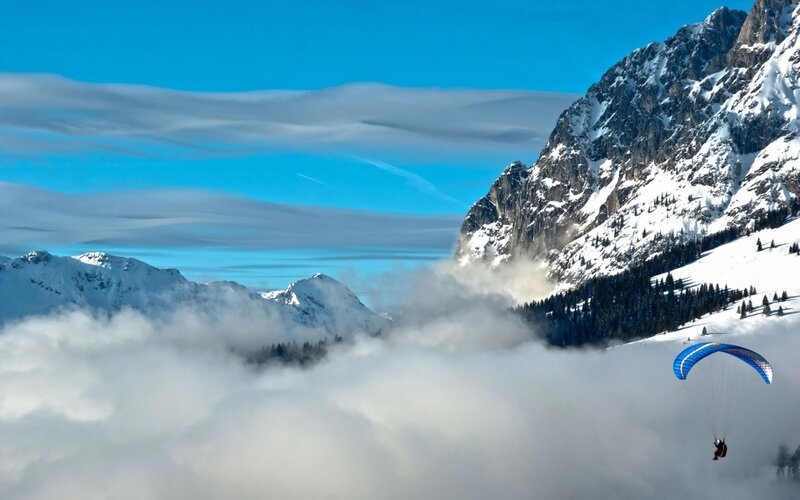 Paraglider in Mountain Clouds