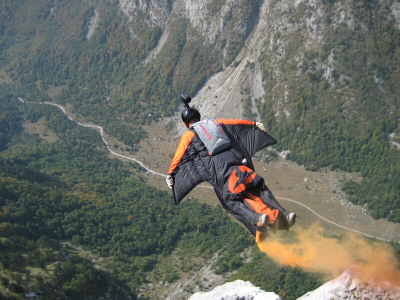 Paraglider in mountain valley