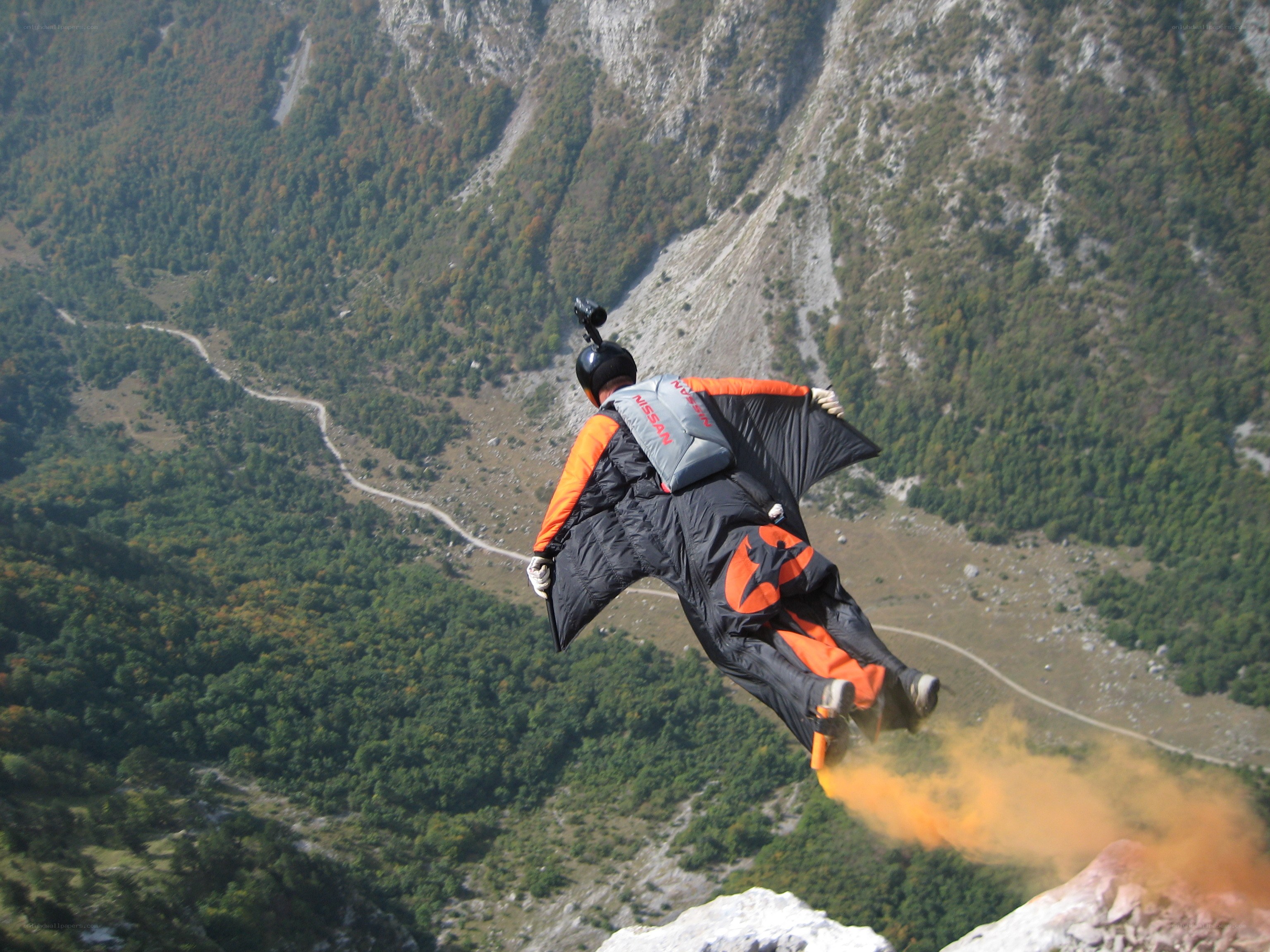 Paraglider in mountain valley