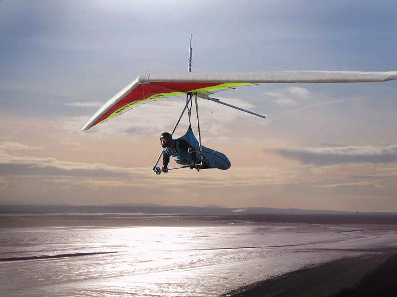 Paraglider over a coastal wetland