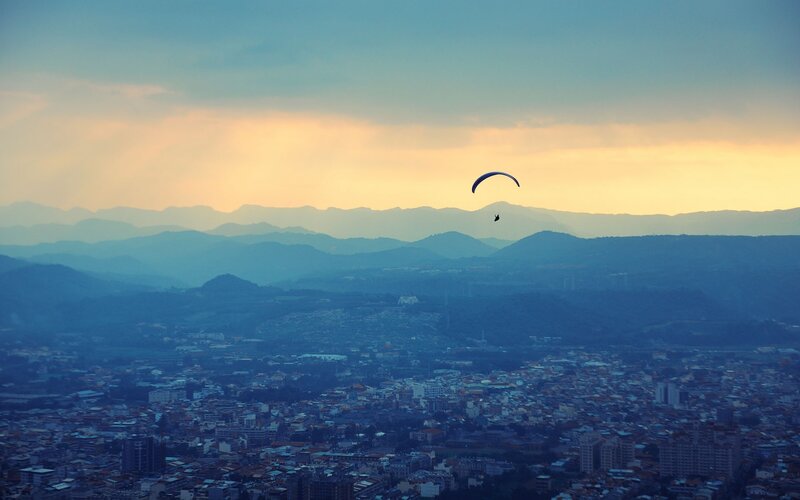 Paraglider over City — Blue