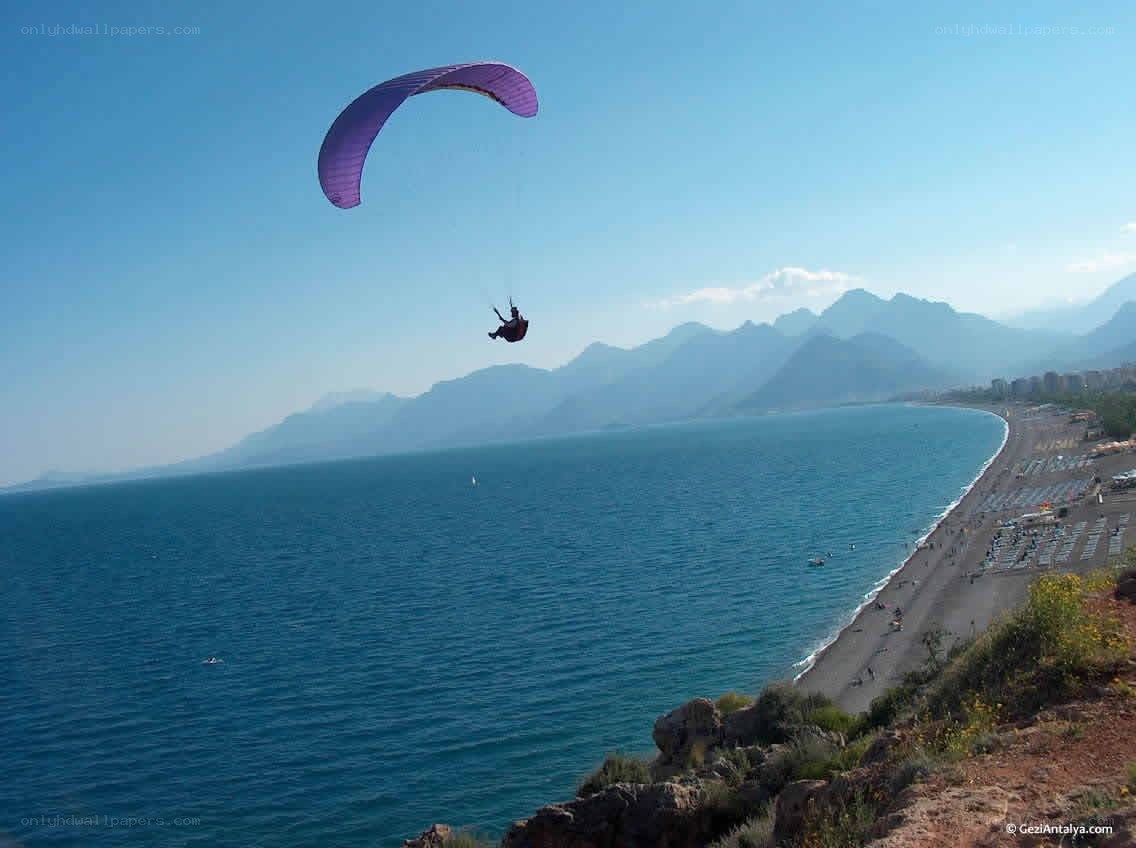 Paraglider over coastal landscape