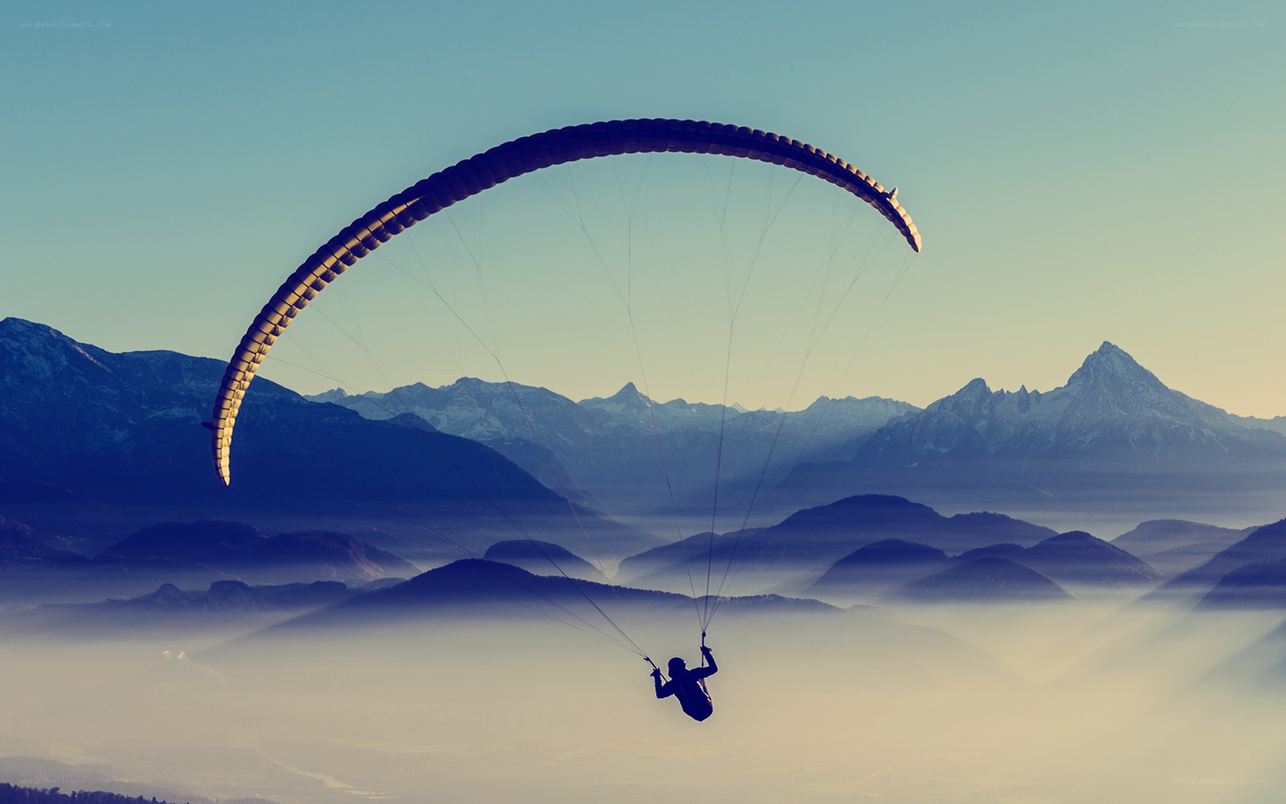 Paraglider over mountain range
