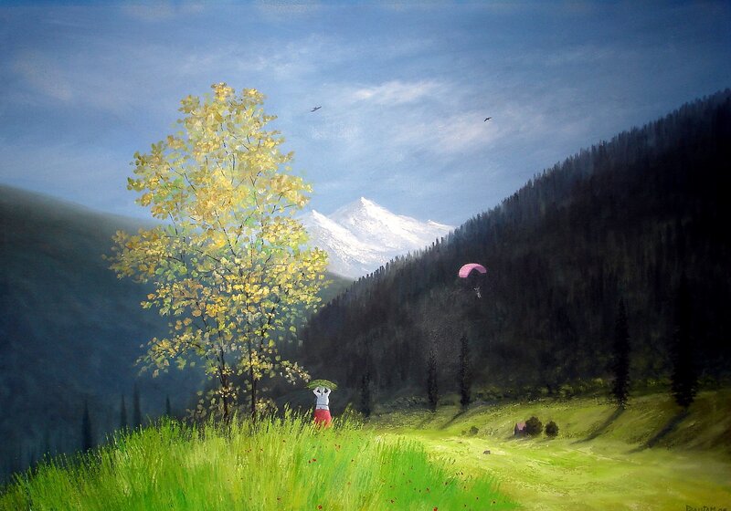 Paraglider over mountain valley